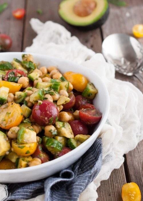 This chickpea salad so light and refreshing with fresh basil, balsamic vinegar, tomatoes, and avocado. Its naturally vegan but has so much flavor, you'd never know it!