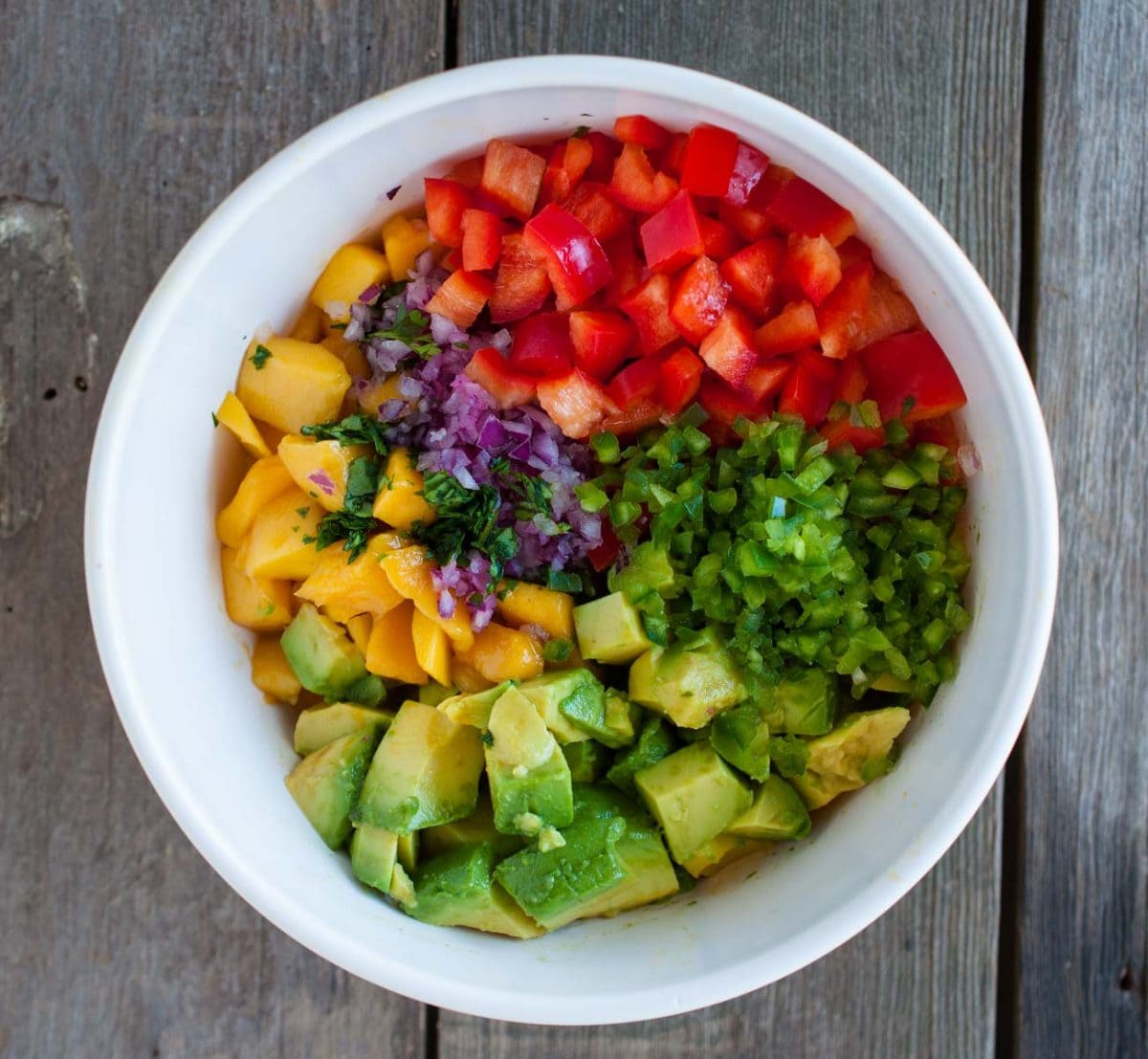 bowl of mango salsa ingredients before stirring together from overhead