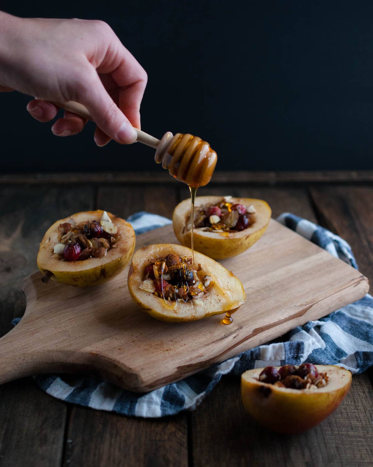 These baked pears with honey and almonds are the perfect healthy dessert for the holidays with cranberries and a nutty crunch all for 200 calories! 