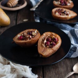 These baked pears with honey and almonds are the perfect healthy dessert for the holidays with cranberries and a nutty crunch all for 200 calories!