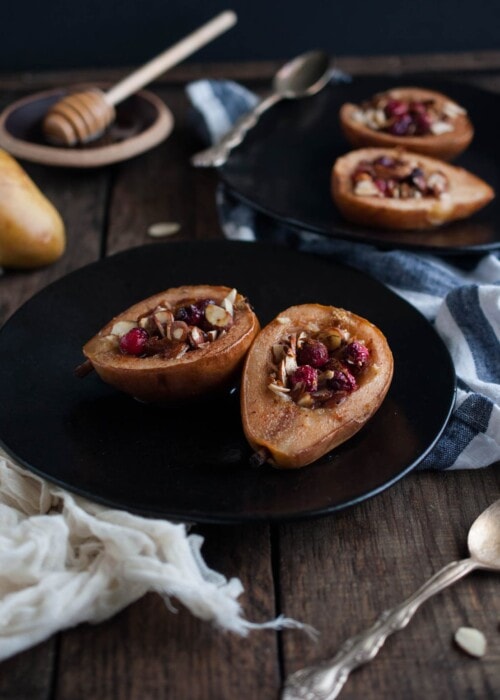 These baked pears with honey and almonds are the perfect healthy dessert for the holidays with cranberries and a nutty crunch all for 200 calories!