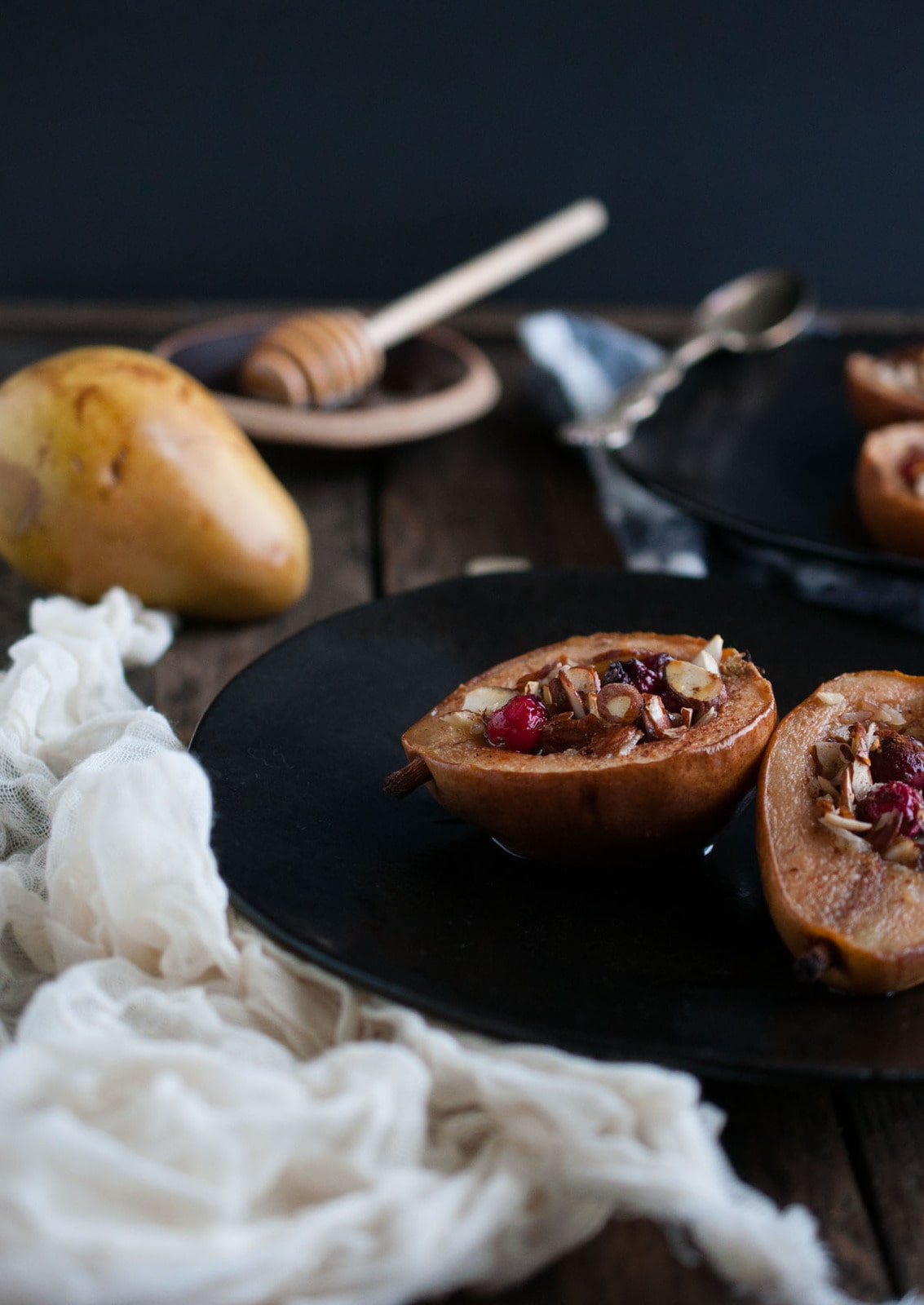 These baked pears with honey and almonds are the perfect healthy dessert for the holidays with cranberries and a nutty crunch all for 200 calories! 