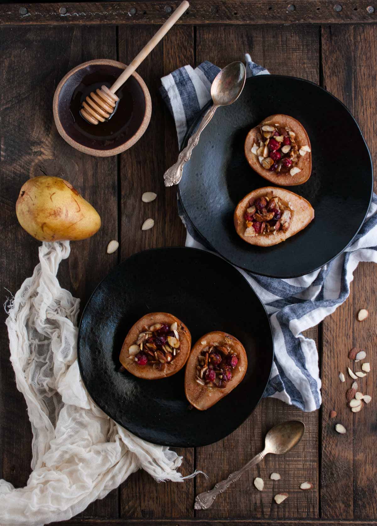 These baked pears with honey and almonds are the perfect healthy dessert for the holidays with cranberries and a nutty crunch all for 200 calories! 