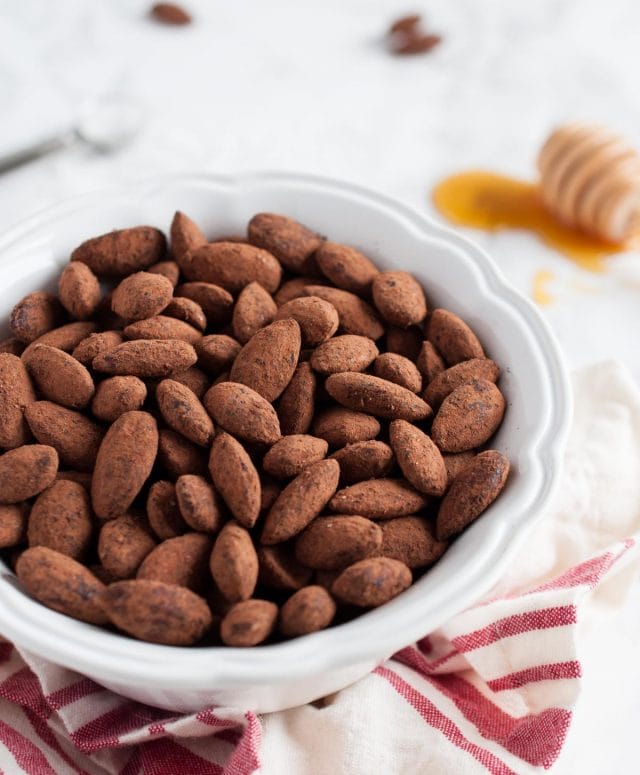 side view of a bowl of cocoa almonds