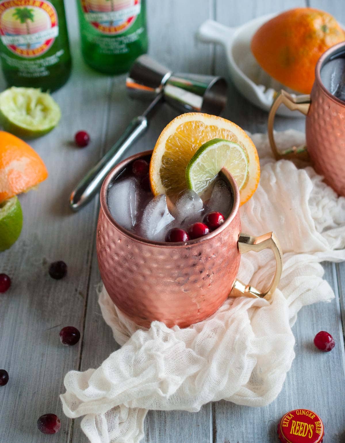 Cranberry Moscow mule recipe made with zesty orange, zippy ginger beer, vodka, lime, and cranberry just might be the most refreshing drink on the planet. Try one today!
