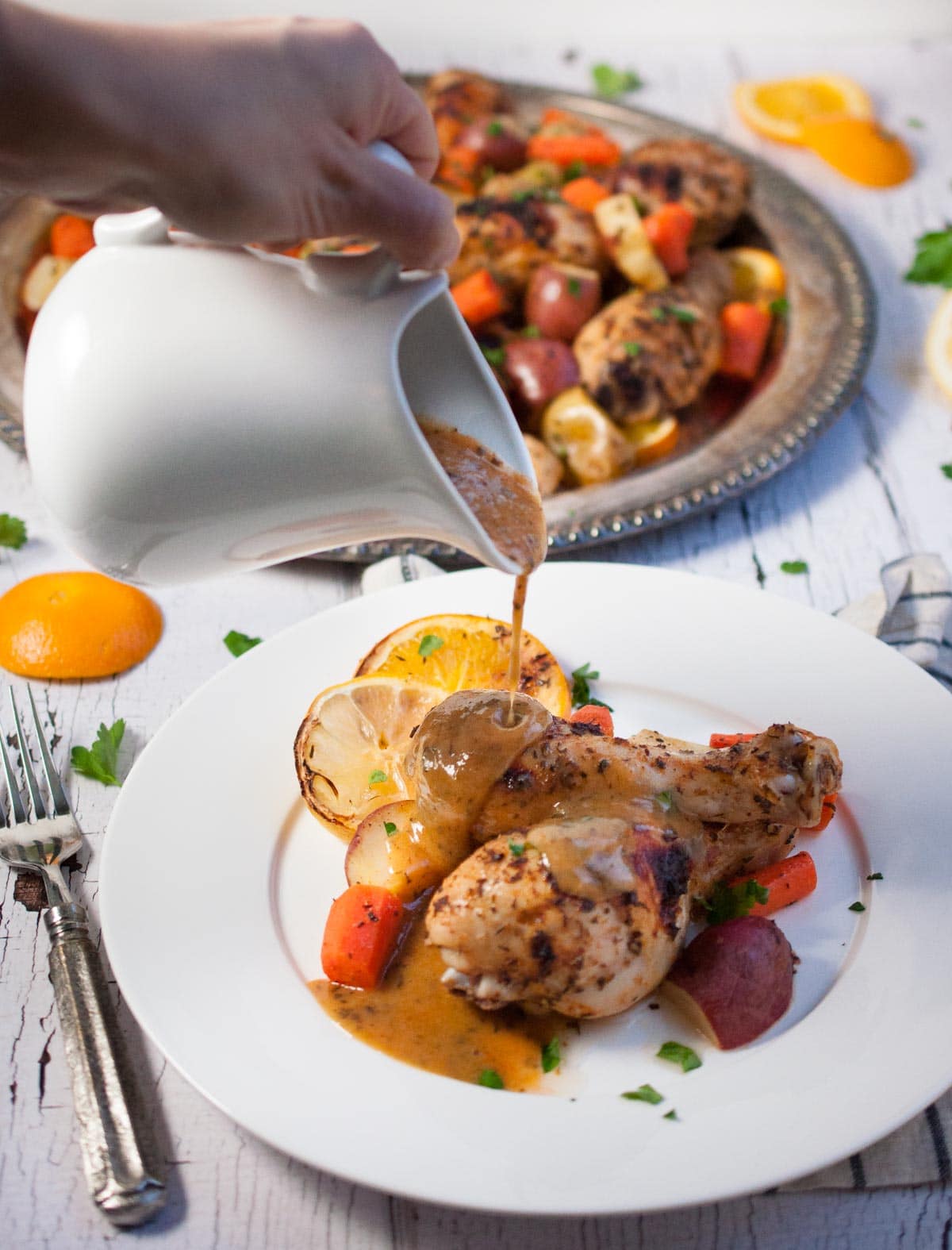 Baked citrus chicken and vegetables is a comforting, delicious, unique one dish meal that is impressive enough to serve to guests without being too fussy.