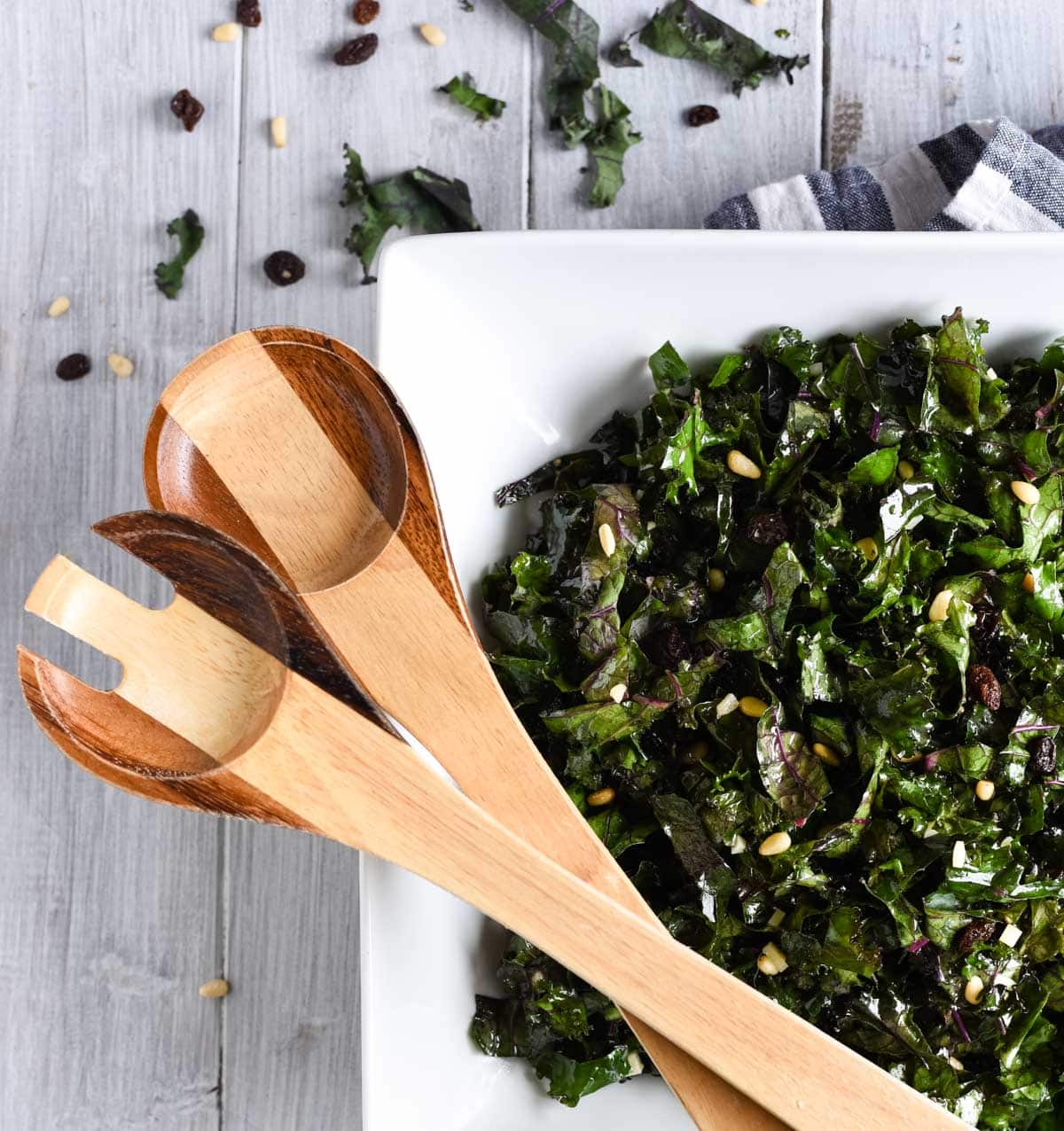 Overhead shot of kale salad with serving spoons