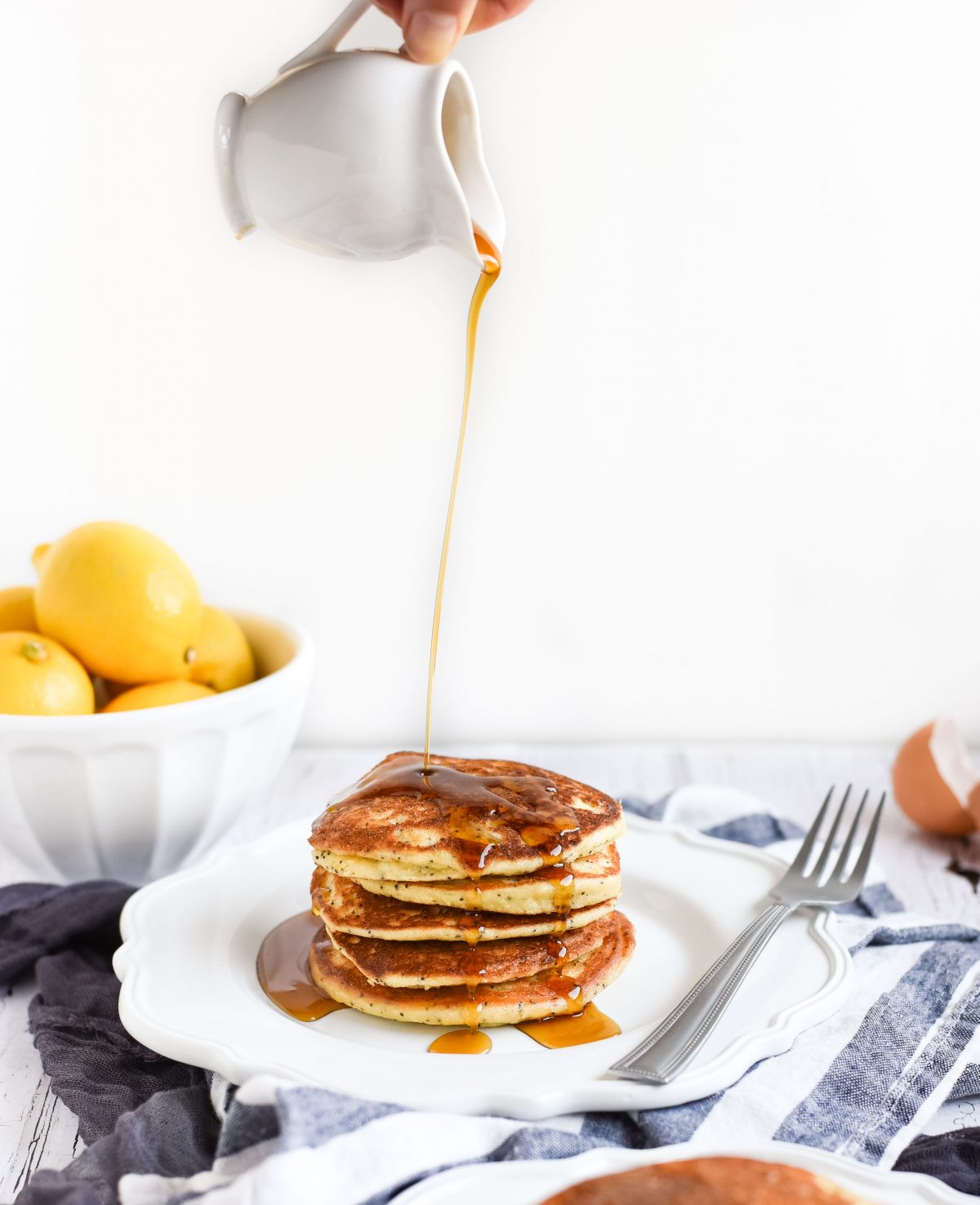 Lemon poppy seed pancakes with syrup drizzled on top picture