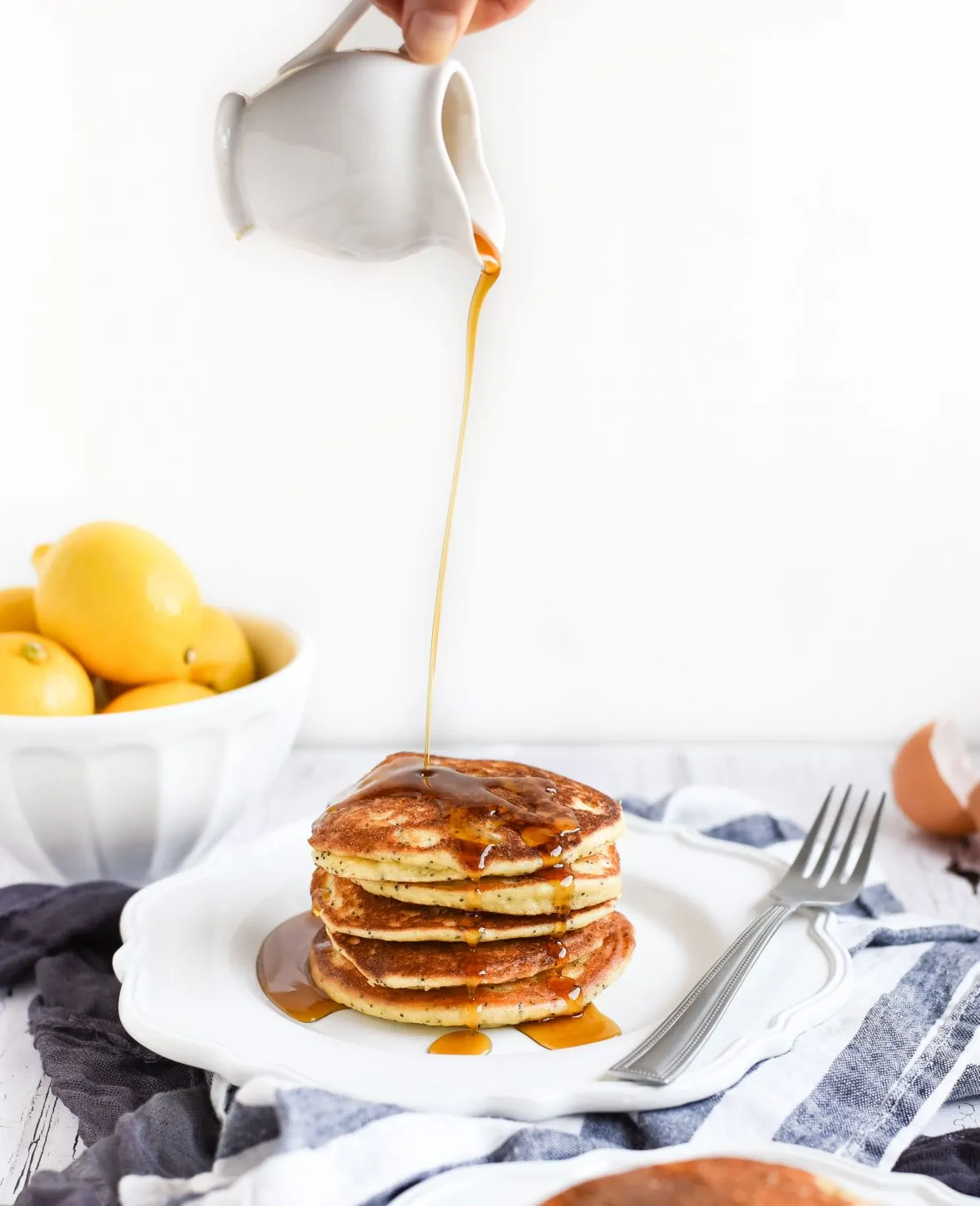 Lemon poppy seed pancakes with syrup drizzled on top picture