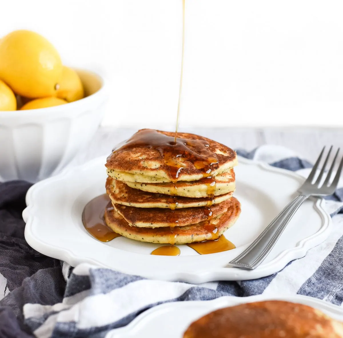  syrup drizzled over Lemon poppy seed pancakes photo