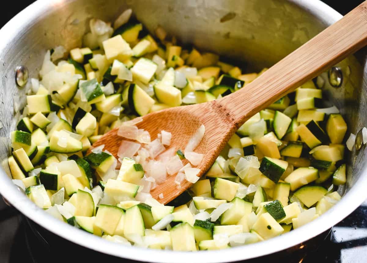 pan full of zucchini being cooked down