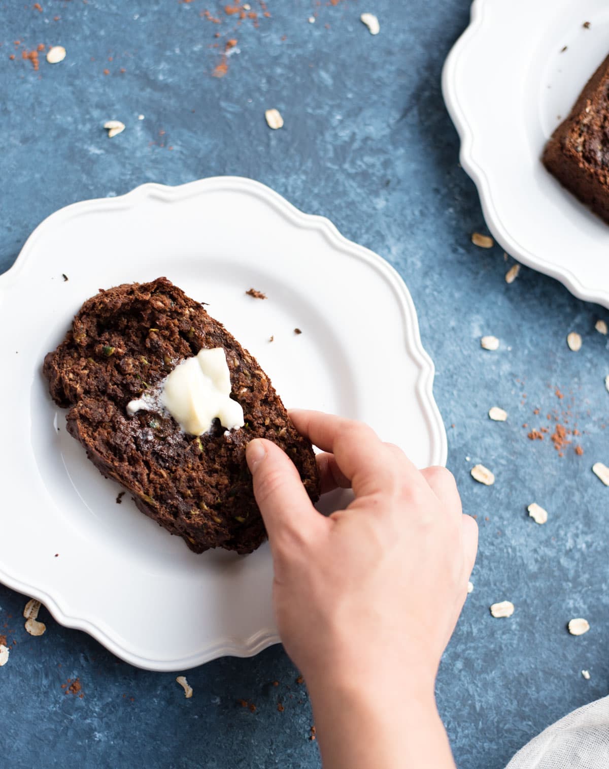 Hand grabbing chocolate zucchini banana bread