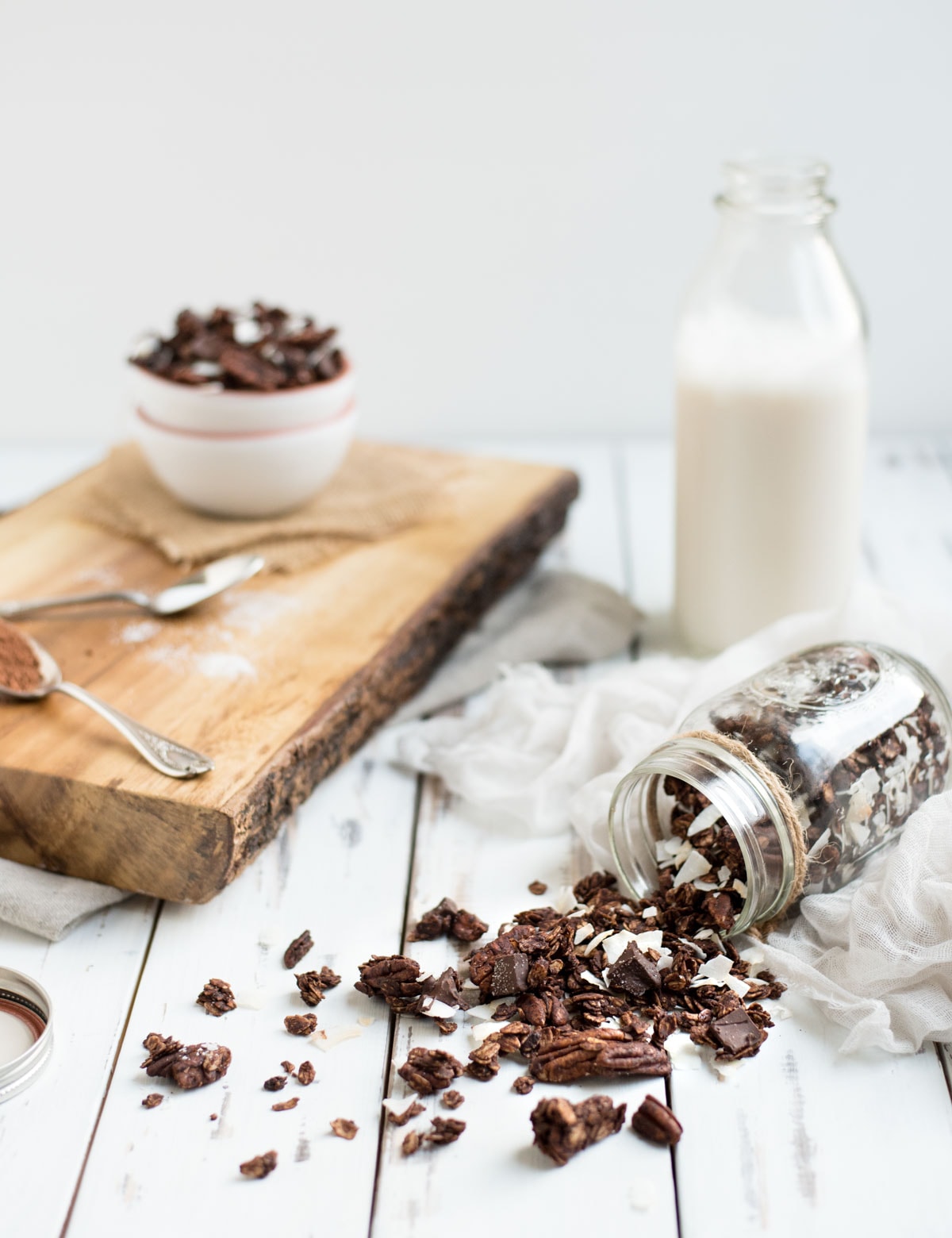 jar of chocolate granola with milk jug 