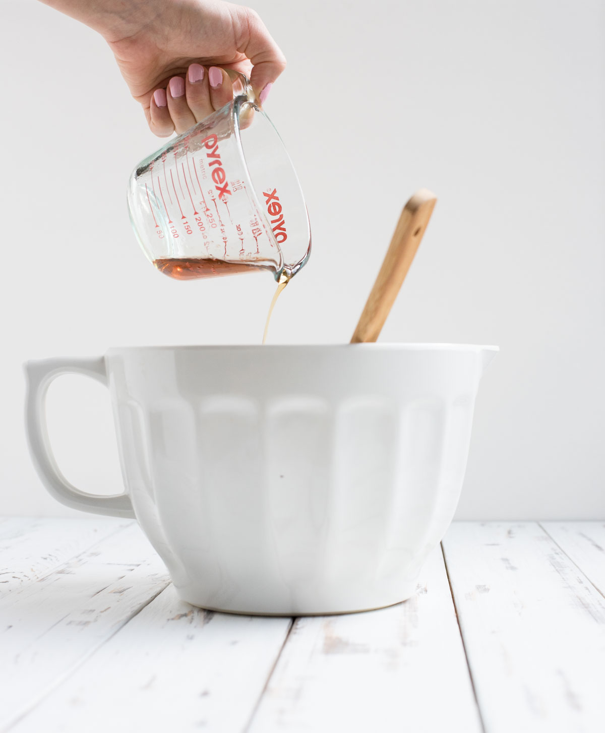 maple syrup being pulled into a mixing bowl 