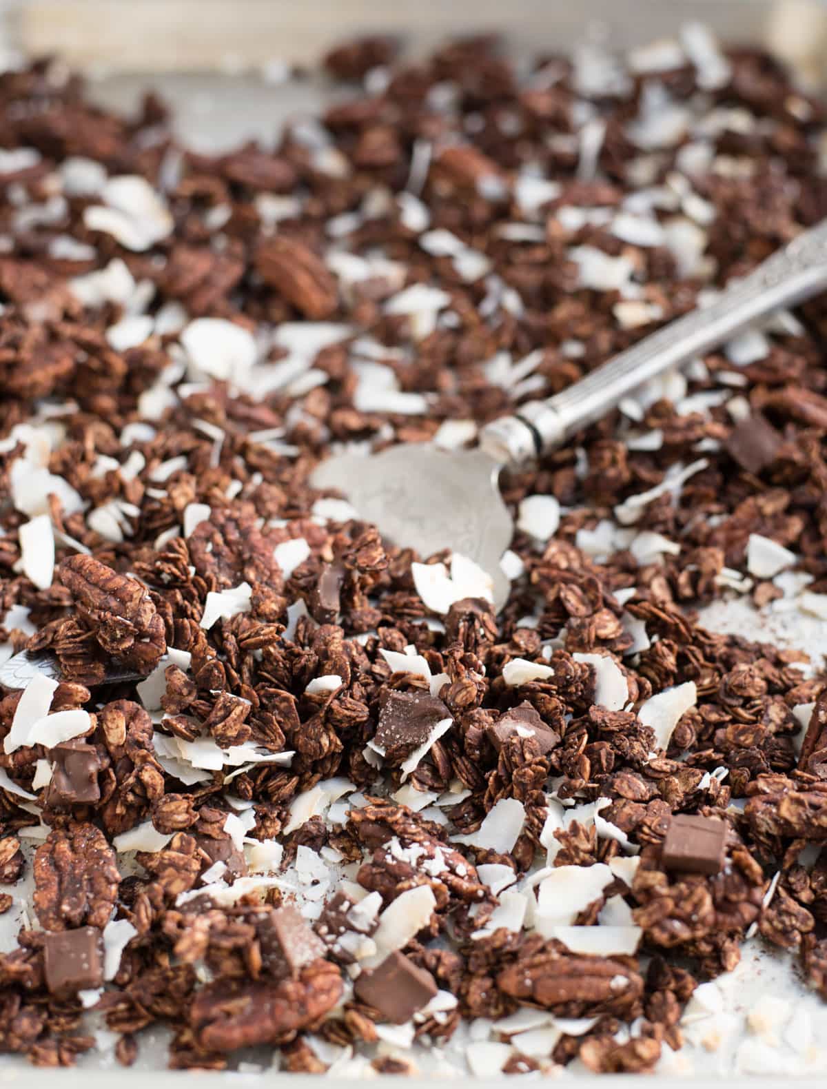 pan of baked chocolate granola with scoop