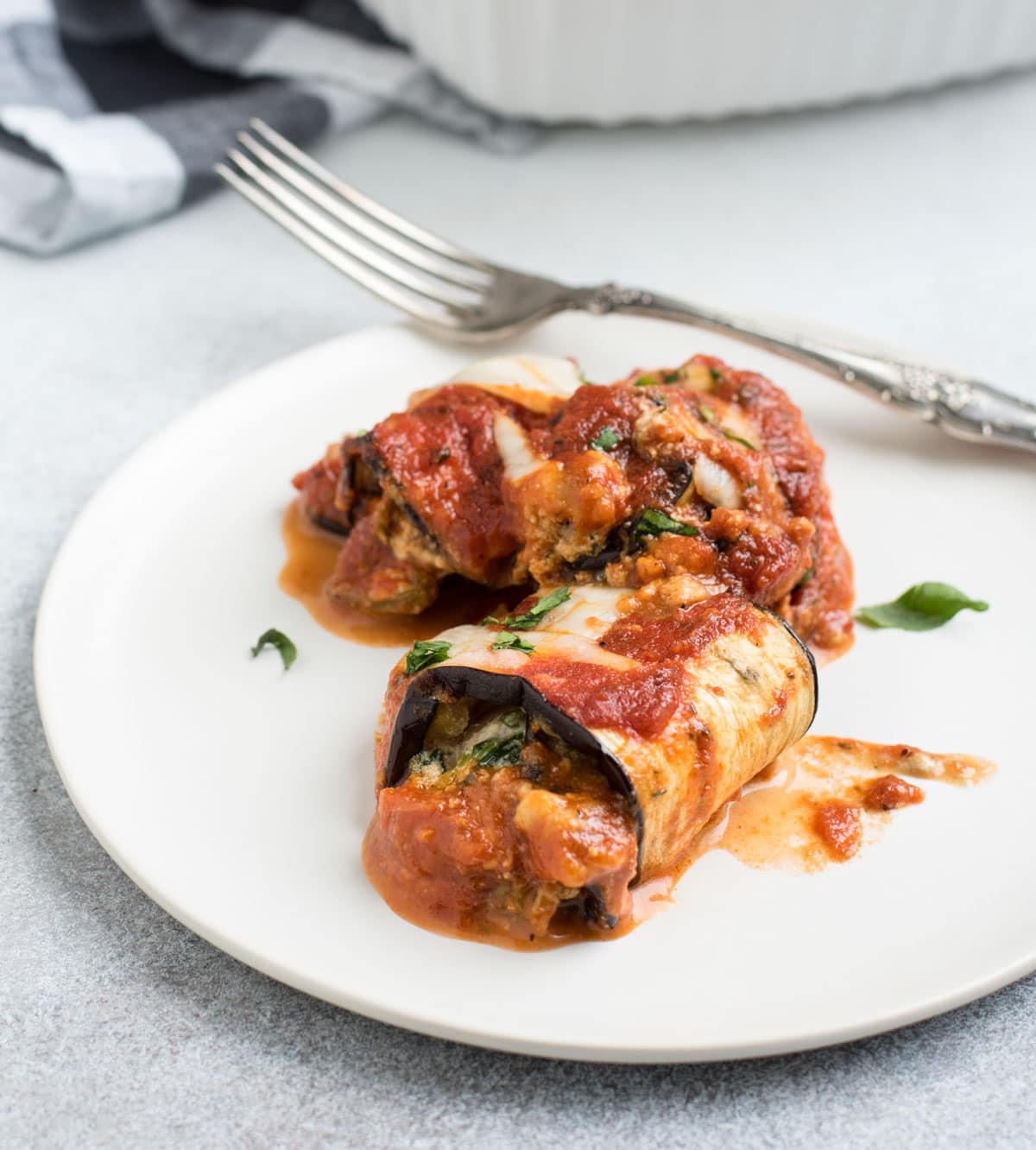 eggplant lasagna roll ups on a plate