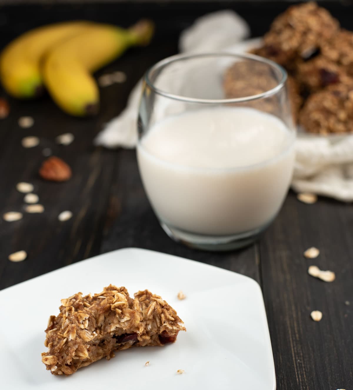 Healthy banana oat cookie on a plate with a glass of milk 