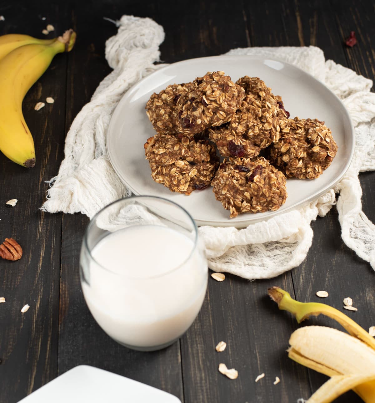 stack of healthy banana oat cookies on a plate with milk