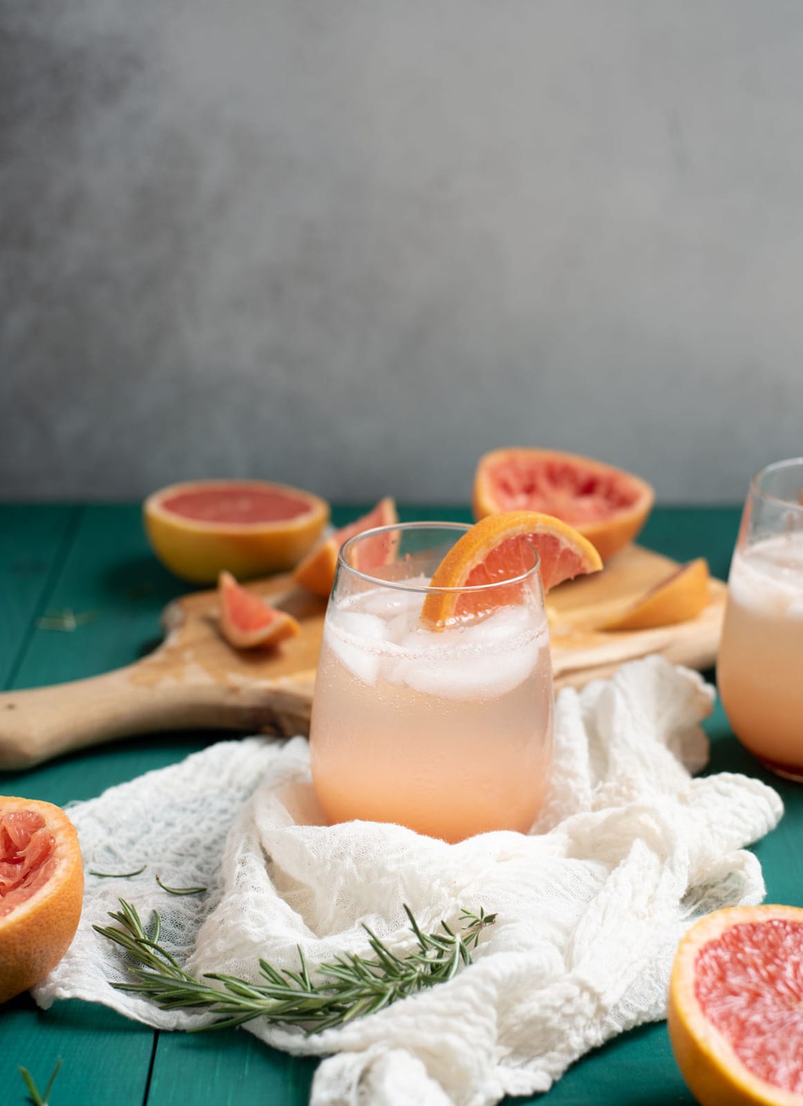 Rosemary grapefruit mocktail in glass with ice cubes