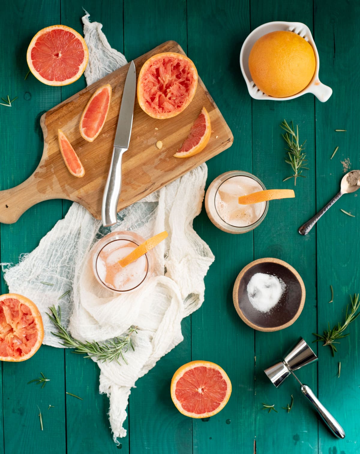 Rosemary grapefruit mocktails on a green tabletop from overhead