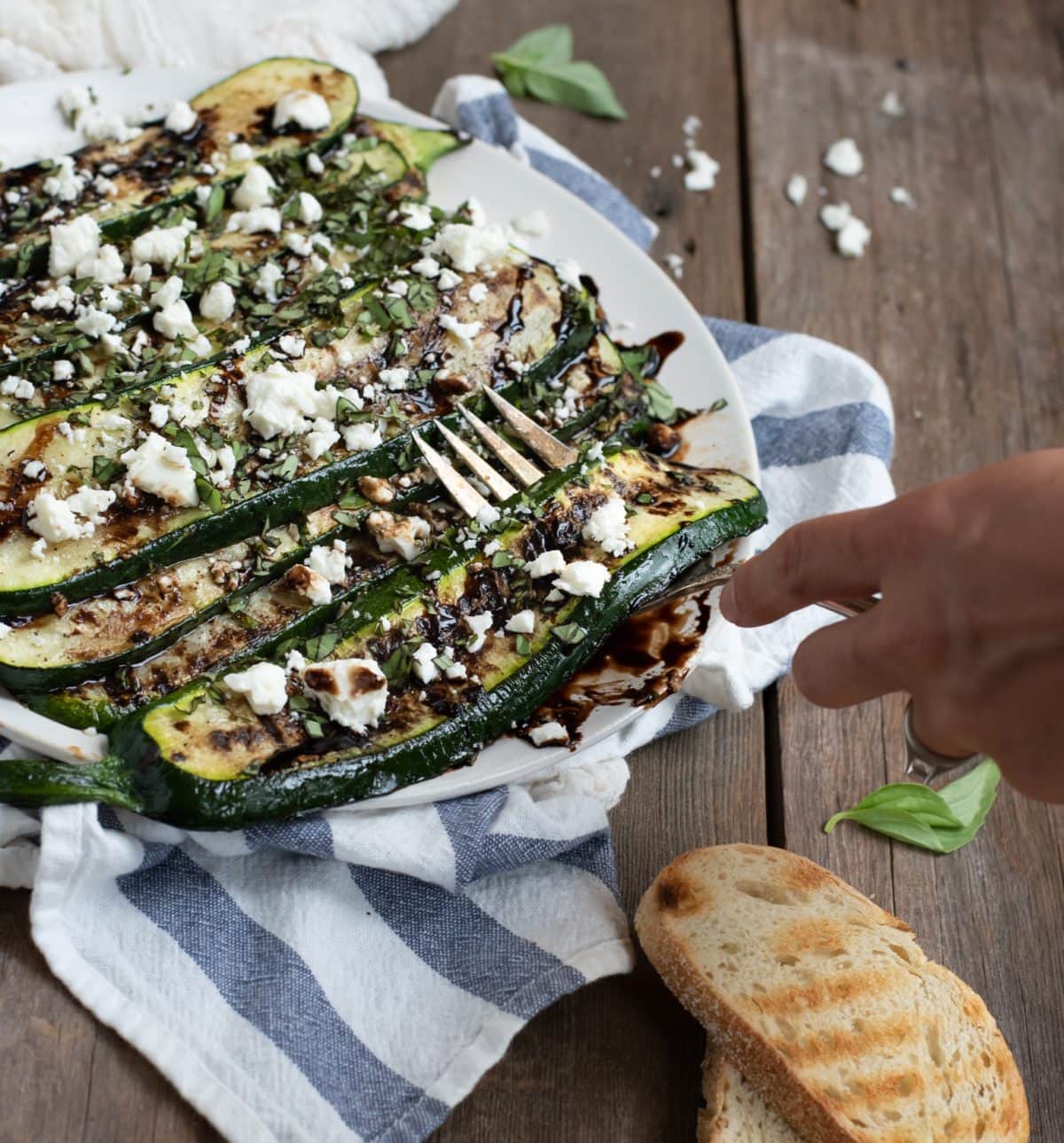 grilled zucchini being lifted with a fork