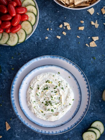 Photo of whipped feta with herbs on blue serving bowl