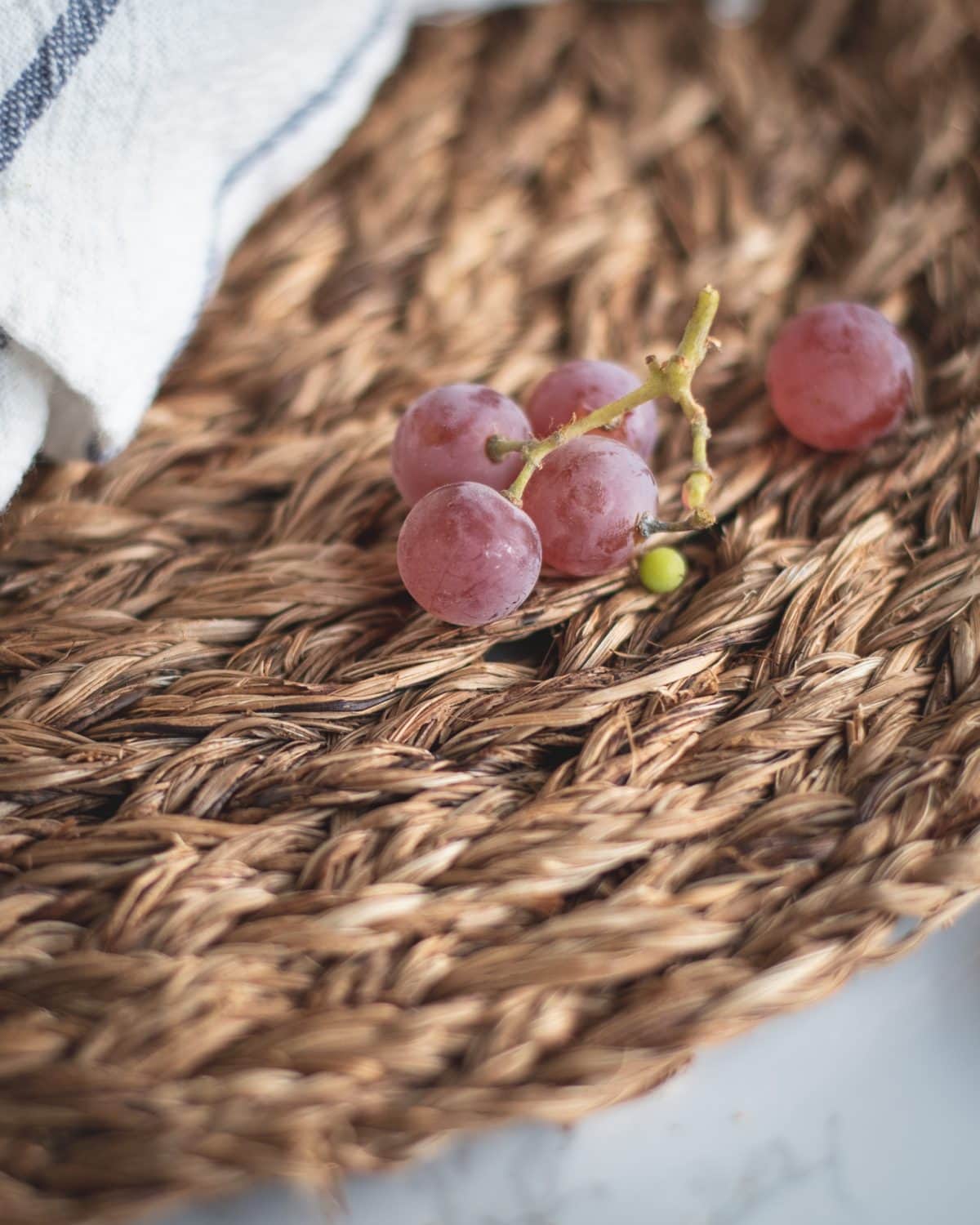 Red grapes on a wicker placemat
