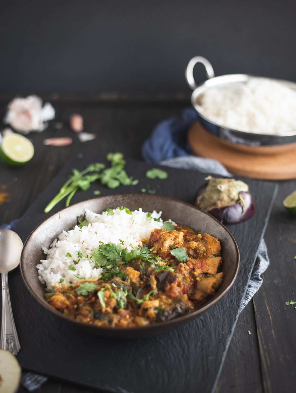 Bowl of Instant Pot chicken curry with eggplant with rice in background