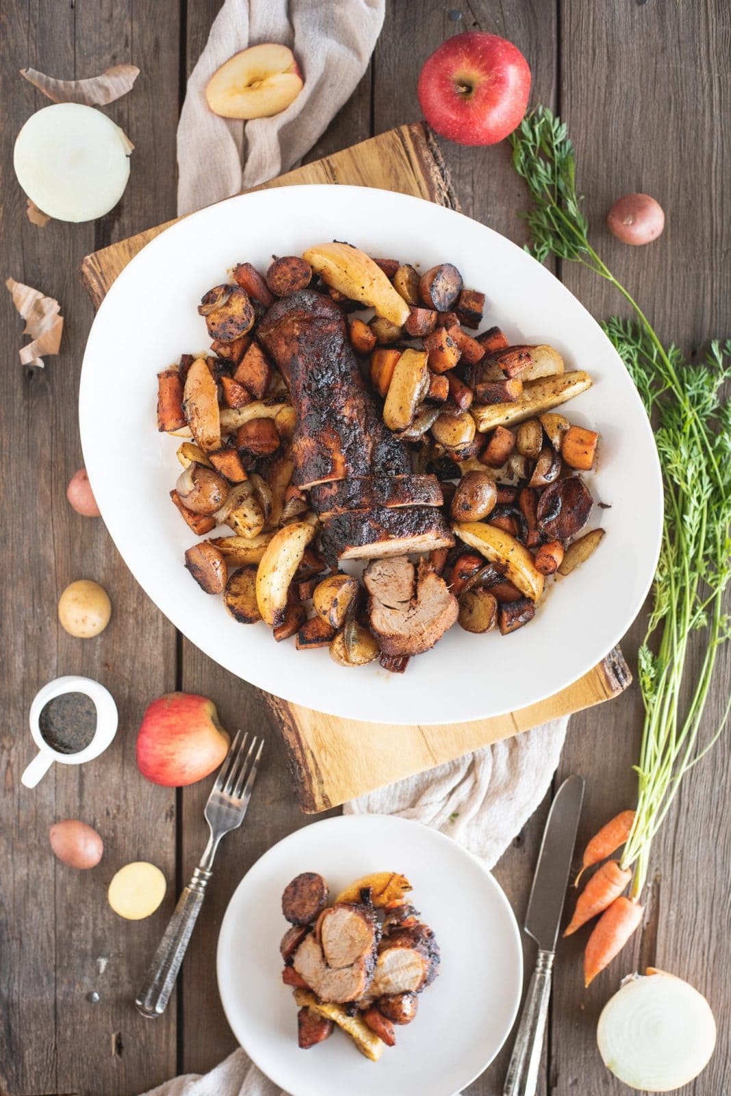 Picture of platter of Pork Tenderloin with Apples and Root Vegetables on wood background