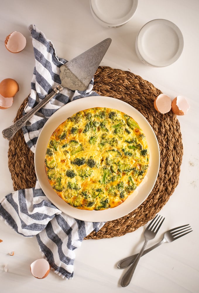 overhead picture of a crustless quiche on a white background