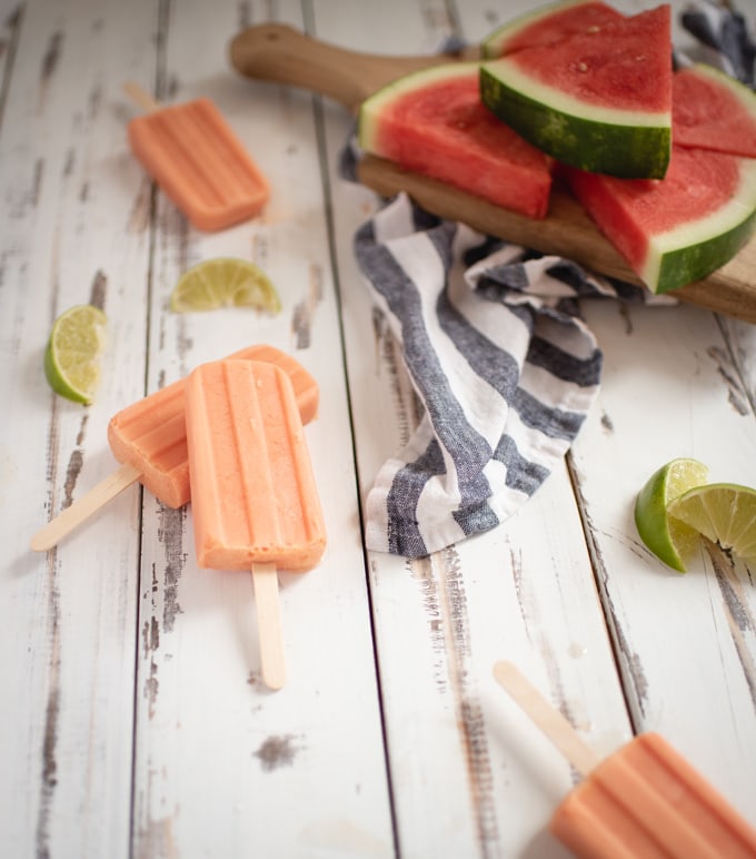 white background with pink popsicles and watermelon wedges