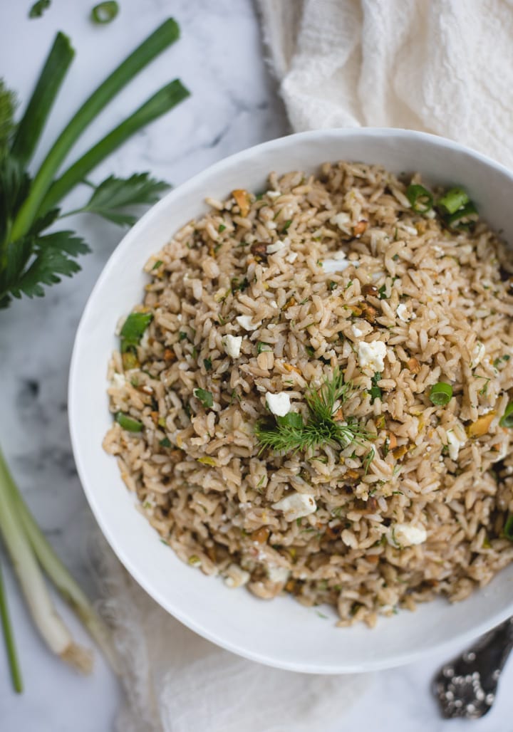 close up overhead picture of lemon brown rice side dish with dill garnishes