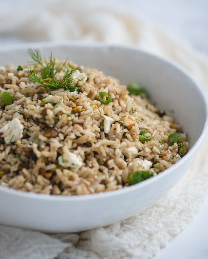 White bowl of lemon brown rice with feta and dill 