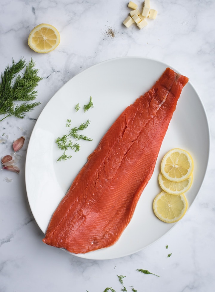 filet of salmon on white background with lemon and dill