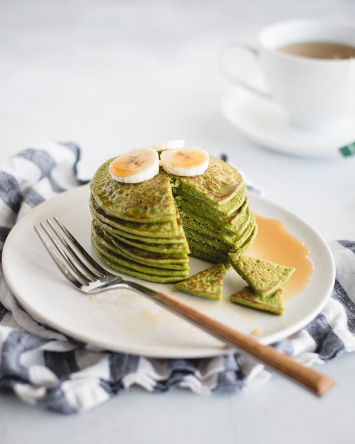 plate of spinach pancakes on white background