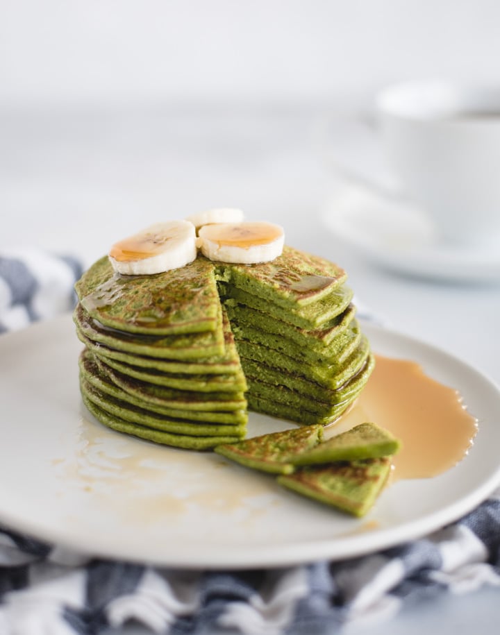 plate with stack of green pancakes 