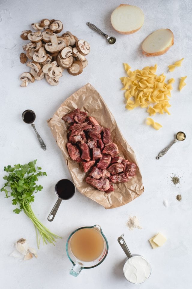 overhead picture of stew beef, noodles, mushrooms and other ingredients