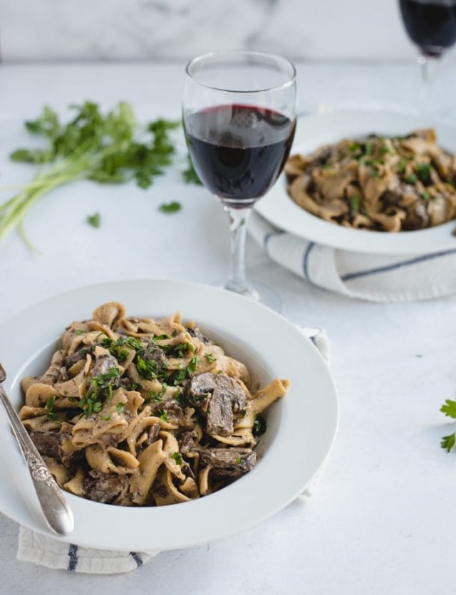 bowls of beef stroganoff with red wine 