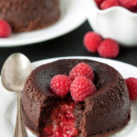 raspberry filled chocolate lava cake with filling spilling out of the center