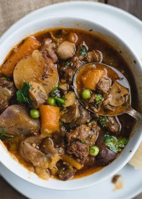 overhead picture of irish beef stew in a white bowl