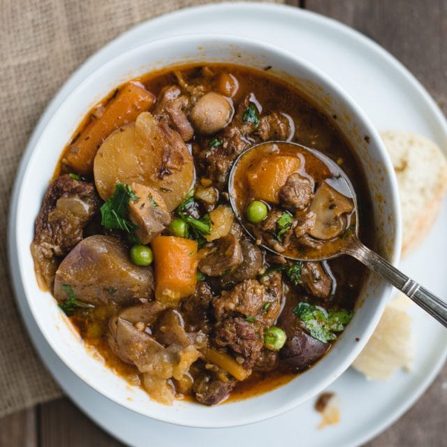 overhead picture of irish beef stew in a white bowl