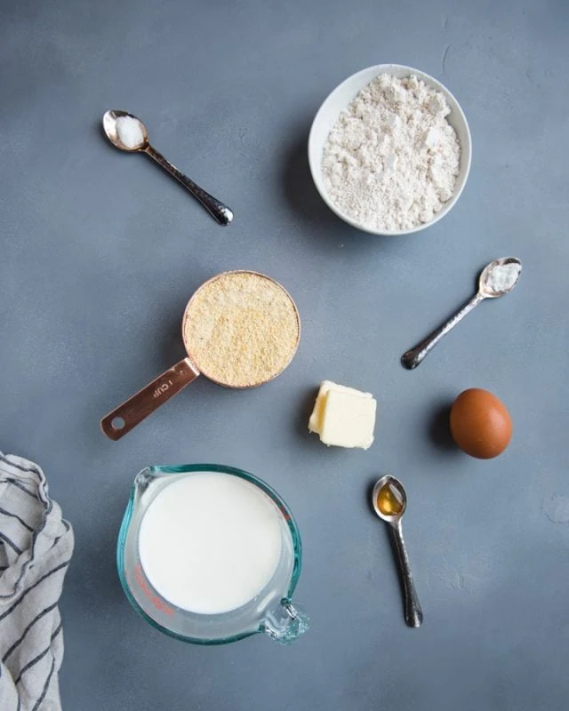 overhead picture of whole wheat cornbread ingredients on a gray background