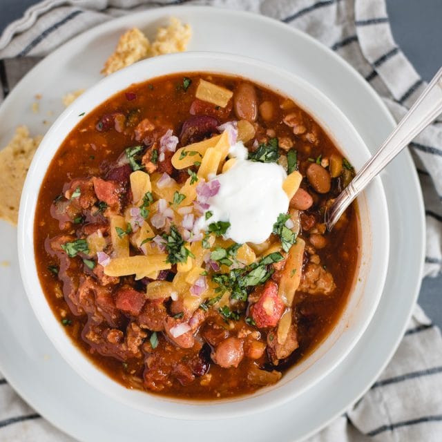 Close up overhead picture of a bowl of turkey chili in a white bowl