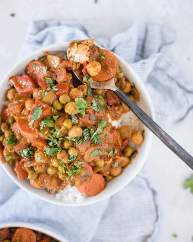 Bowl of chickpea curry with spoonful of curry resting on the edge