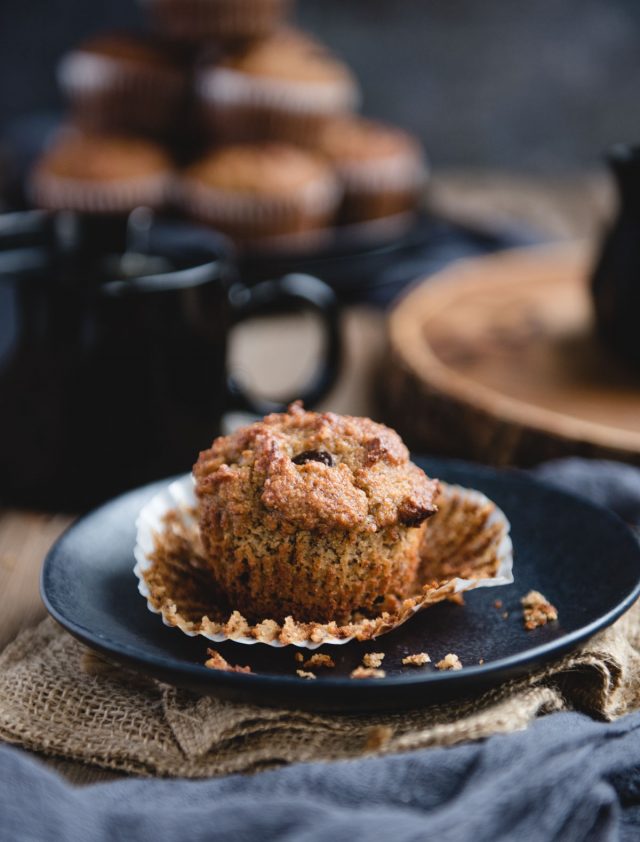 Close up picture of an almond flour banana muffin on a black plate