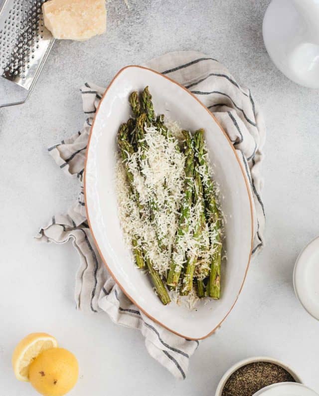 overhead picture of air fryer asparagus against a light background