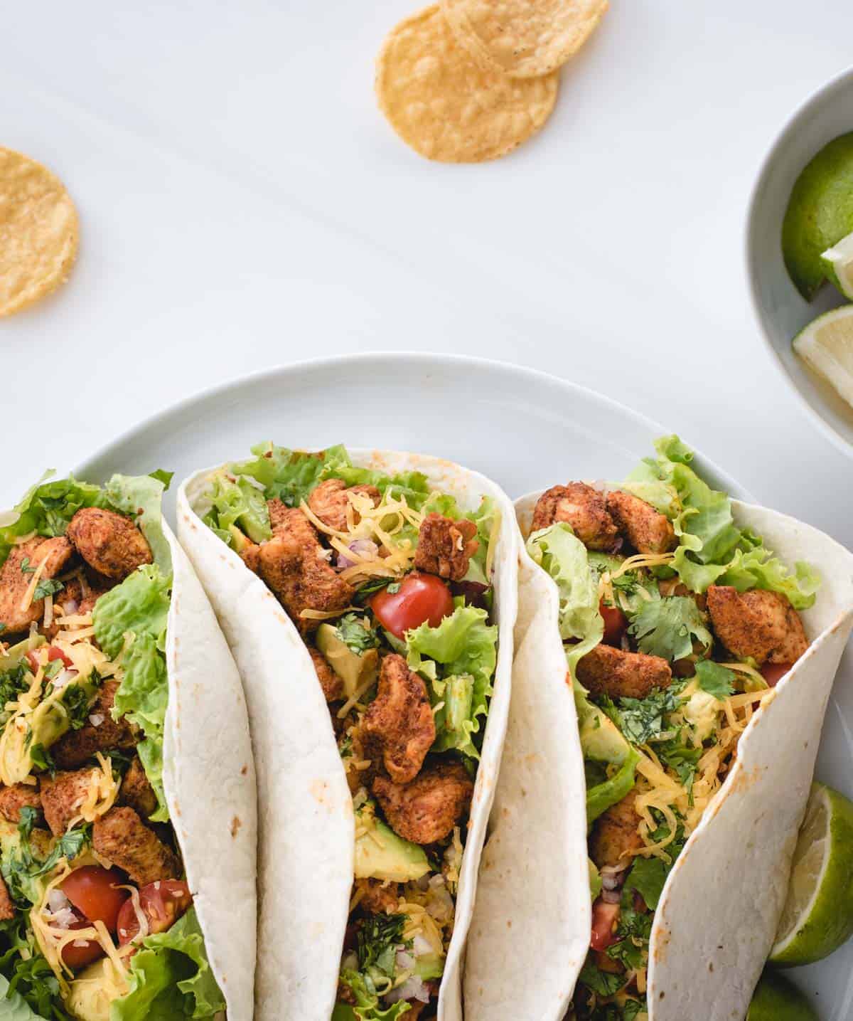 overhead of three soft shell tacos on a plate