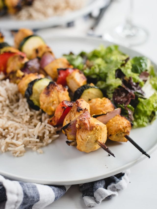 close up picture of marinated yogurt chicken kabobs on a plate