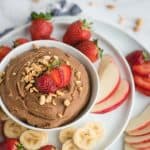 bowl of chocolate hummus with crushed peanuts on top