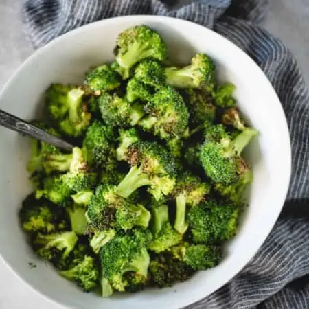 white bowl of air fried broccoli